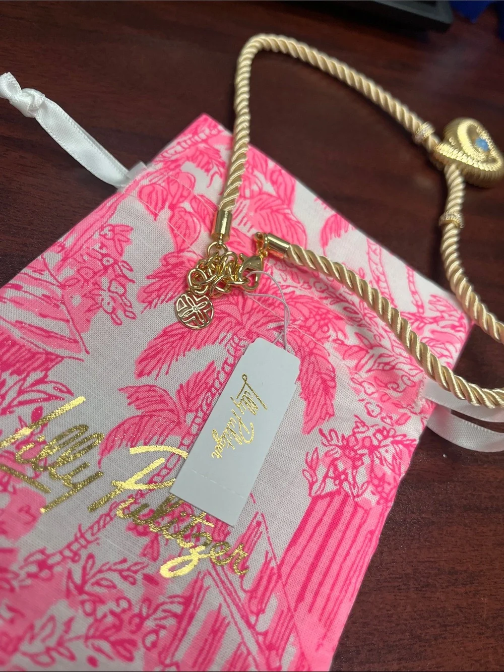 Lilly Pulitzer gold shell with blue stone! Gold cord with accents. Beautiful.